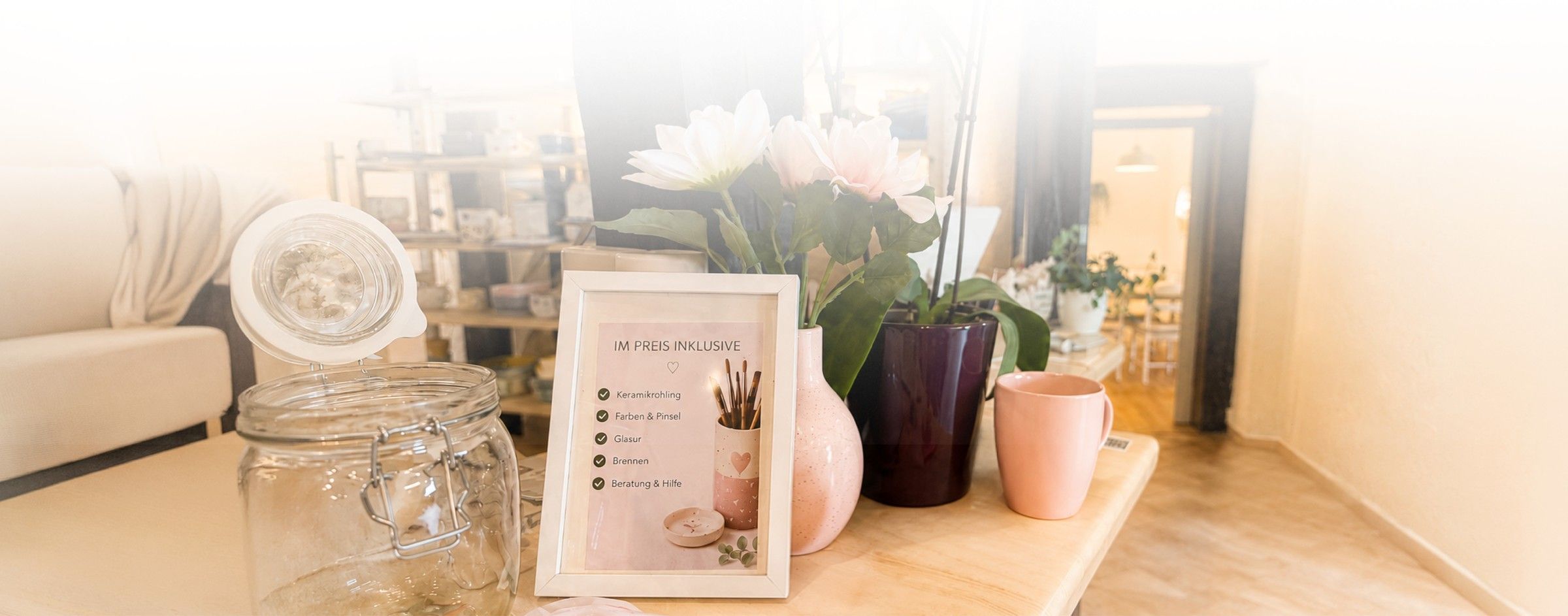 Gemütlicher Tisch mit Blumen und Keramik im Studio